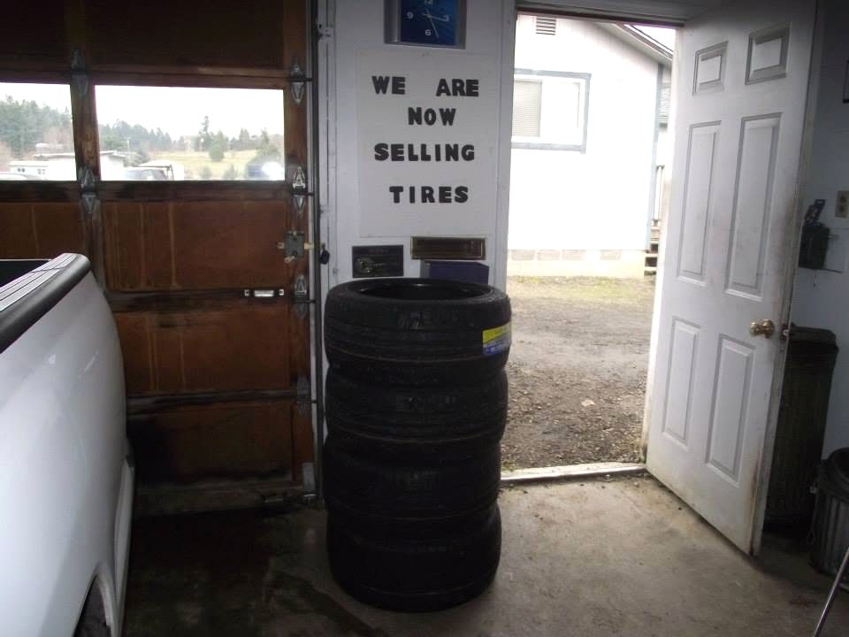 Hand-painted "we are now selling tires" sign at M.D. Automotive in Sutherlin, OR